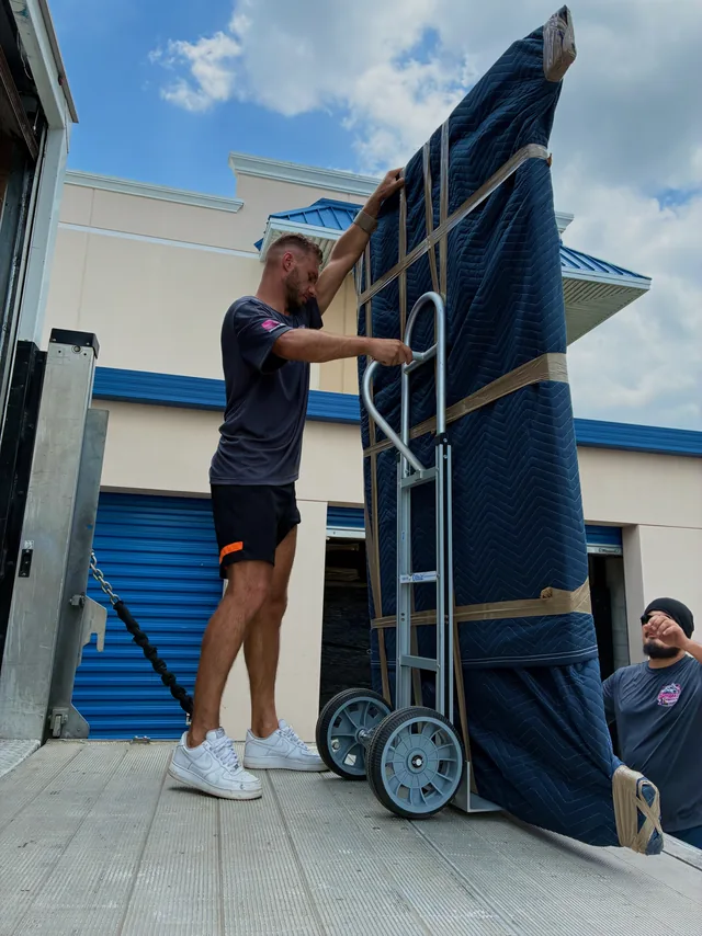 Mover tilting an oversized wrapped panel onto a dolly