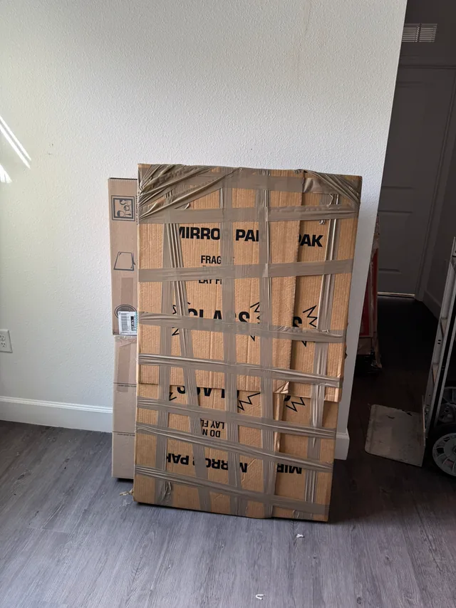 Framed mirror boxed in a mirror pack ready to load