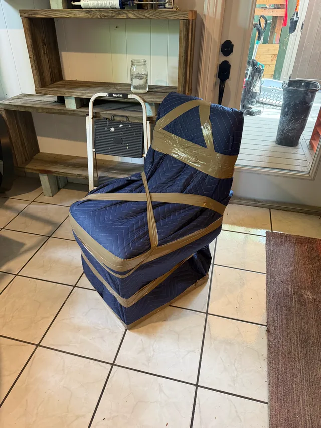 Storage unit packed floor to ceiling with wrapped, strapped furniture